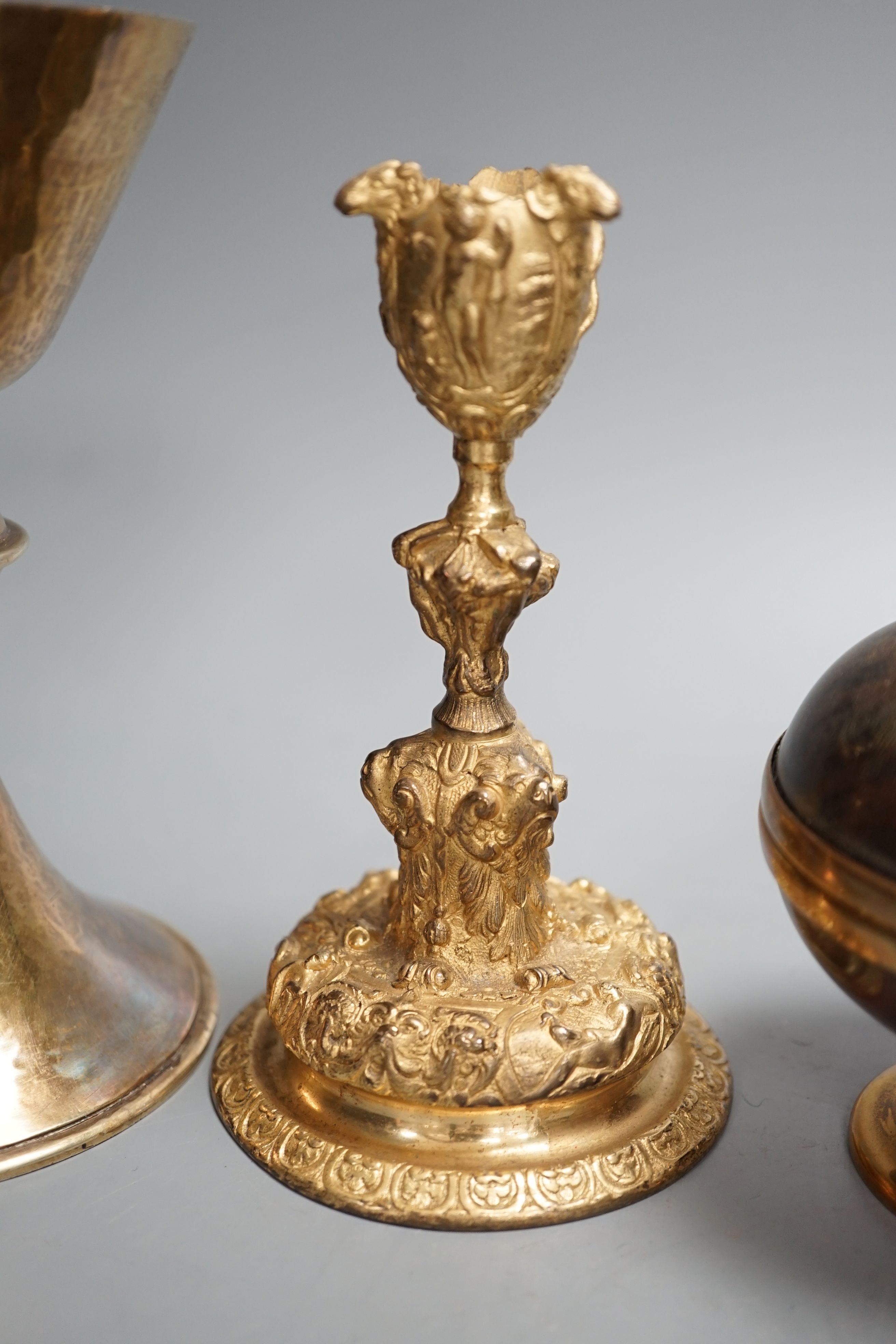 A decorative ormolu inkwell, 20cm high, a Baroque style candlestick, a chalice stamped W IV, together with a faux tortoiseshell pot (4)